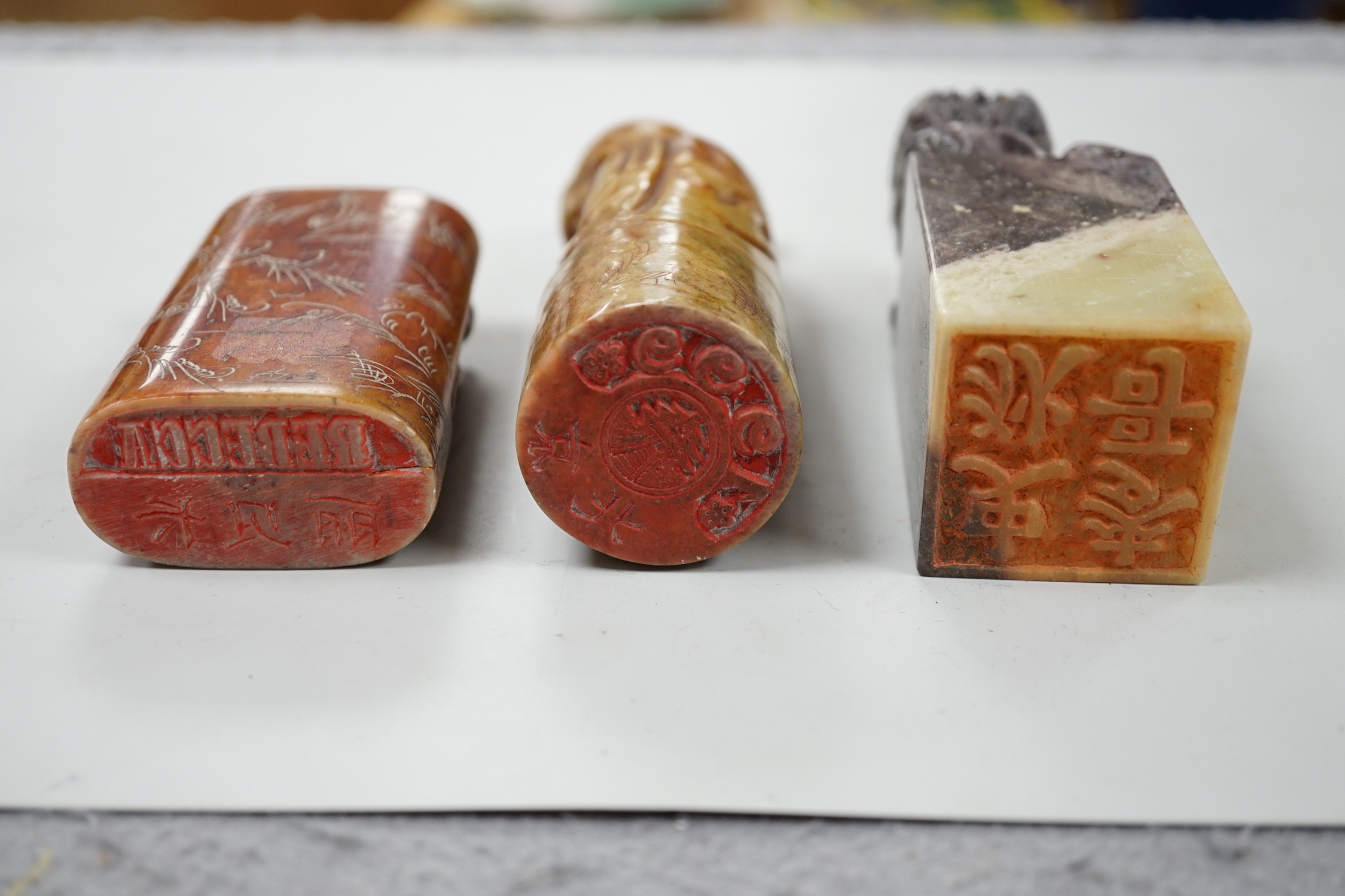 Three Chinese soapstone seals, tallest 12cm high